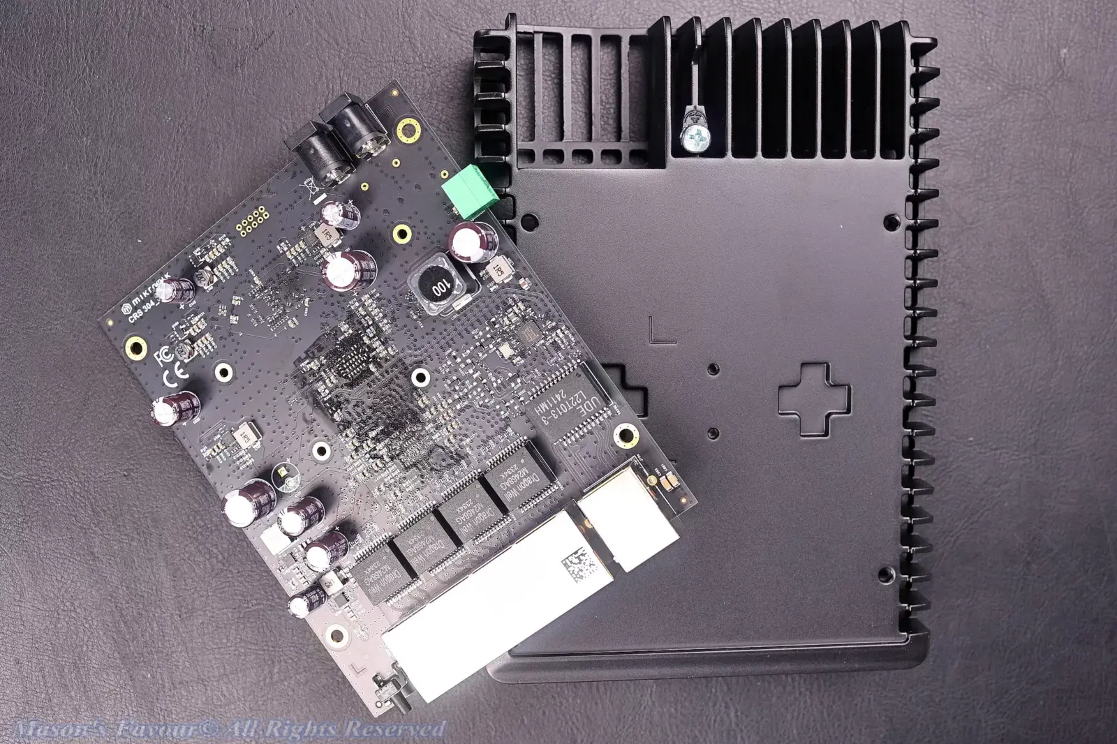 MikroTik CRS304-4XG-IN - PCB & Bottom Heatsink Base, and the shitty Electrolytic Capacitors almost full of the PCB